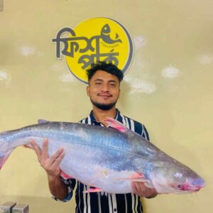 Young Bangladeshi fish seller holding a large fresh Sea Pangas fish at a local seafood market in Fish Park